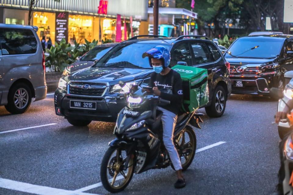 A GrabFood rider is pictured in Kuala Lumpur 16, 2020. — Picture by Firdaus Latif