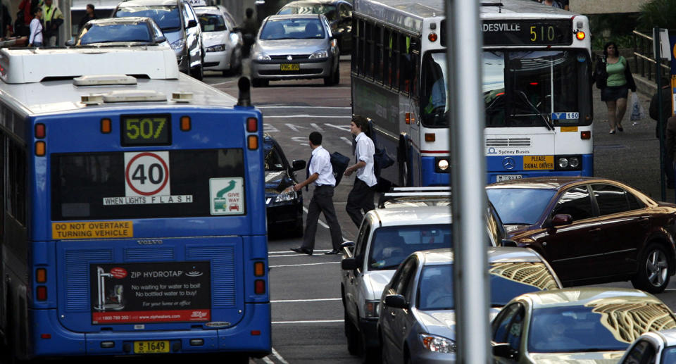 A NSW bus with 40 speed limit sign and flashing lights signals drivers to slow to 40km/h.