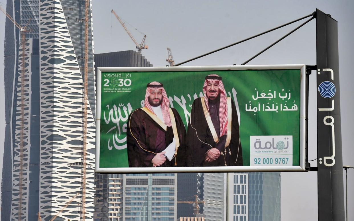 Portraits of Saudi King Salman (R) and his son Crown Prince Mohammed bin Salman on display in Riyadh as the city prepares for a major investment conference - AFP