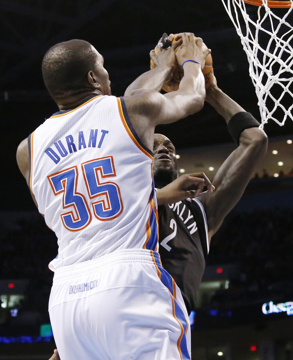 Oklahoma City Thunder forward Kevin Durant (35) blocks a shot by Brooklyn Nets center Kevin Garnett (2) in the second quarter of an NBA basketball game in Oklahoma City, Thursday, Jan. 2, 2014. (AP Photo/Sue Ogrocki)