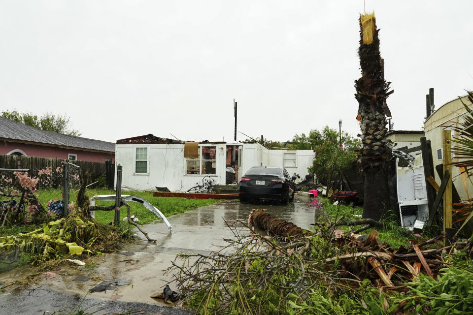 The roof is torn off a home surrounded by debris following a tornado touching down Saturday, May 13, 2023, in Laguna Heights, Texas.At least one person was killed when a tornado struck an unincorporated community on the Gulf coast near the southern tip of Texas, damaging dozens of homes and knocking down power lines early Saturday, authorities said. (Denise Cathey/The Brownsville Herald via AP)