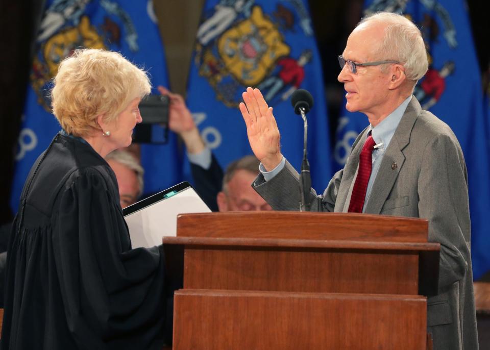 Chief Justice Patience D. Roggensack (left) administers the oath of office to Secretary of State Douglas La Follette.