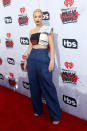 <p>Iggy Azalea, who is currently in the midst of dealing with some relationship drama, seemed confused in her idiosyncratic ensemble. The rapper paired blue wide-leg trousers with a one-shoulder crop top that was seemingly made of multiple vintage T-shirts stitched together. <i><i>(Photo: Getty Images)</i></i></p>