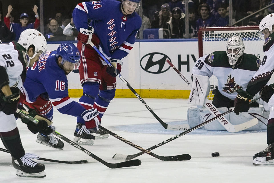 New York Rangers' Vincent Trocheck, second from left, shoots at the goal, during an NHL hockey game against the Arizona Coyotes, Monday, Oct. 16, 2023, in New York. (AP Photo/Bebeto Matthews)