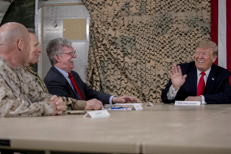 President Donald Trump, right, jokes with National Security Adviser John Bolton, third from left, and senior military leadership, as he speaks to members of the media at Al Asad Air Base, Iraq, Wednesday, Dec. 26, 2018. (Photo: Andrew Harnik/AP)