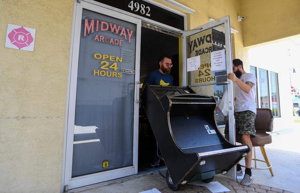 Movers with Lauren Florida Trucks of Palm Bay remove slot machines from inside Midway Arcade, an adult arcade at 4986 South 25th St., on Tuesday, May 9, 2023, in Fort Pierce, during a statewide raid of such arcades that agents discovered operated illegal slot machines. The Florida Gaming Control Commission investigates complaints against facilities that are believed to be running an illegal operation. Slot machines became illegal July 1, 2022, except at 15 approved casinos.