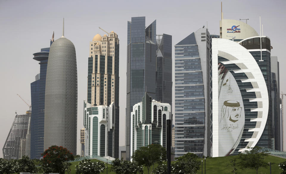 In this May 5, 2018 photo, a giant image of the Emir of Qatar Sheikh Tamim bin Hamad Al Thani, adorns a tower in Doha, Qatar. Kuwait’s foreign ministry announced Monday, Jan. 4, 2021 that Saudi Arabia will open its air and land borders with Qatar in the first steps toward ending a diplomatic crisis that has deeply divided regional U.S. allies since 2017. (AP Photo/Kamran Jebreili)