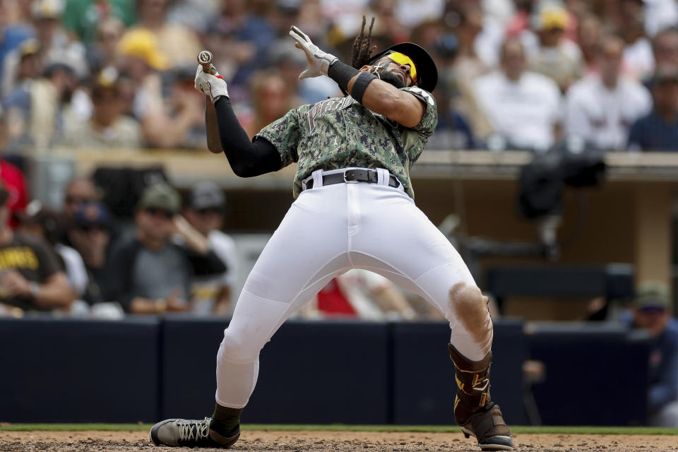 San Diego Padres' Fernando Tatis Jr. dodges a high pitch during the sixth inning of a baseball game against the Boston Red Sox on Sunday, May 21, 2023, in San Diego. (AP Photo/Brandon Sloter)