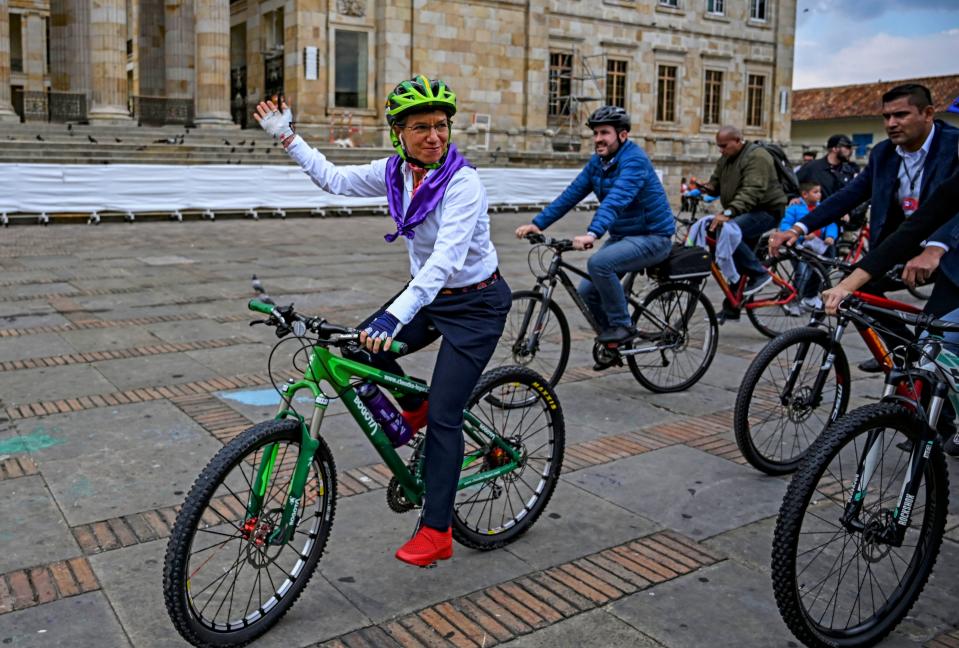 Bogota's Mayor Claudia Lopez (L) rides a bike at the Plaza Bolivar square, after attending a demonstration for the International Women's Day, in Bogota, on March 8, 2020. (Photo by Juan BARRETO / AFP) (Photo by JUAN BARRETO/AFP via Getty Images)