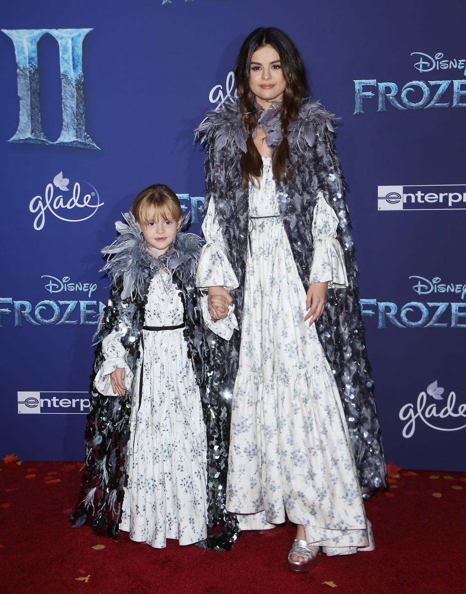A full-length view of the sisters' matching outfits. (Photo: Michael Tran via Getty Images)