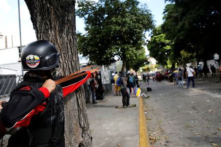 A demonstrator uses a slingshot at a rally during a strike called to protest against Venezuelan President Nicolas Maduro's government in Caracas. REUTERS/Carlos Garcia Rawlins