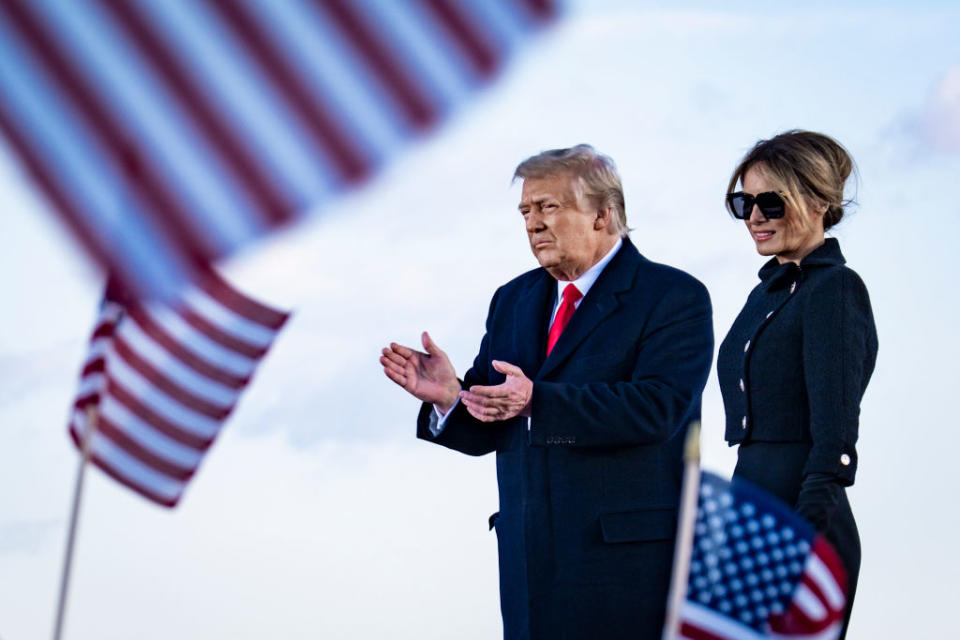 President Donald Trump and First Lady Melania Trump on stage after speaking to supporters at Joint Base Andrews before boarding Air Force One.