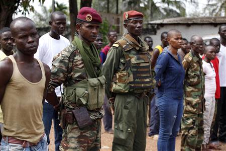 Christian and Muslim soldiers stand next to each other in Bangui December 9, 2013. REUTERS/Emmanuel Braun