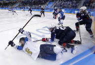 <p>Annina Rajahuhta, left, of Finland, falls after colliding with Lee Stecklein (2), of the United States, during the third period of the semifinal round of the women’s hockey game at the 2018 Winter Olympics in Gangneung, South Korea, Monday, Feb. 19, 2018. (AP Photo/Matt Slocum) </p>