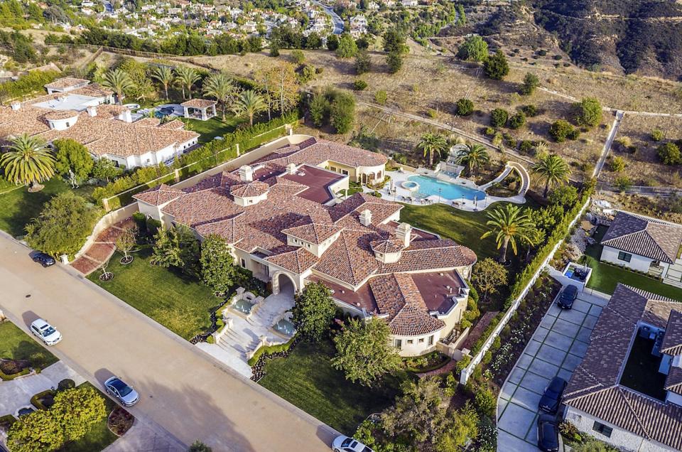 An aerial shot of the property, which more clearly shows how giant it is; it also reveals that it has a large pool in the backyard