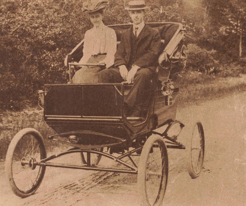 Grace Watson Smith sits in the driver's seat of the second automobile in New Bedford, beside John Hall in the passenger seat. Smith's father was Elias C. Watson, the city's first car dealer.
