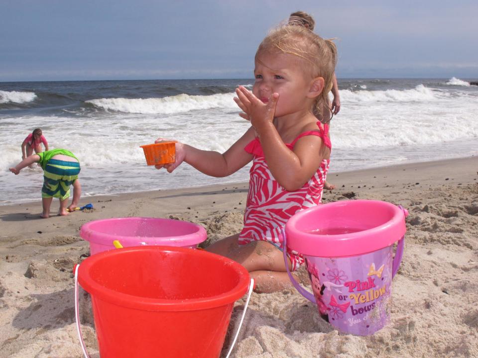 In this Aug. 29, 2013 photo, Addison Hunt of Nazareth, Pa. plays in the sand on the Belmar, NJ beach. Tourism officials say New Jersey's post-Superstorm Sandy advertising campaign this year was good, but came too late to save the summer season. They told state officials on Dec. 12, 2013 that a new campaign needs to start within weeks to help save next summer's tourism season from perceptions that the shore is still devastated by the Oct. 2012 storm. (AP Photo/Wayne Parry)