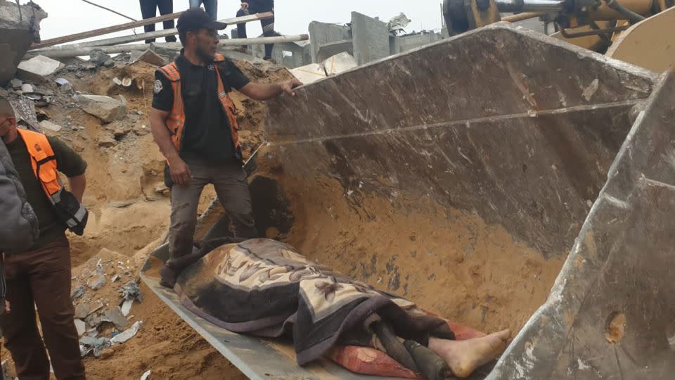 Palestinian Civil Defense at the site of the attack on the Al-Jazzar family home where a giant crater was seen in the aftermath. Journalists in the area told CNN that 18 people were killed. - From Palestinian Civil Defense/Facebook