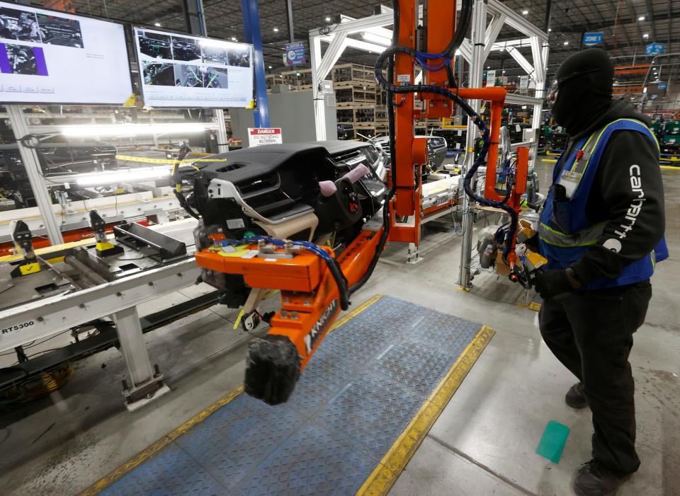 Derrick Hughes, 33, of Warren, and an instrument panel loader, moves it down the line at Dakkota Integrated Systems in Detroit on Thursday, May 5, 2022. The manufacturing plant where the old Kettering High School was, now makes the instrument panels for various Jeep models.