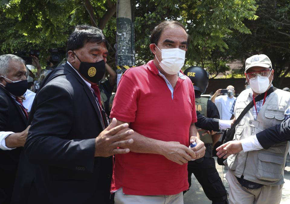 Popular Action party presidential candidate Yonhy Lescano, center, arrives to vote during general elections in Lima, Peru, Sunday, April 11, 2021. (AP Photo/Martin Mejia)