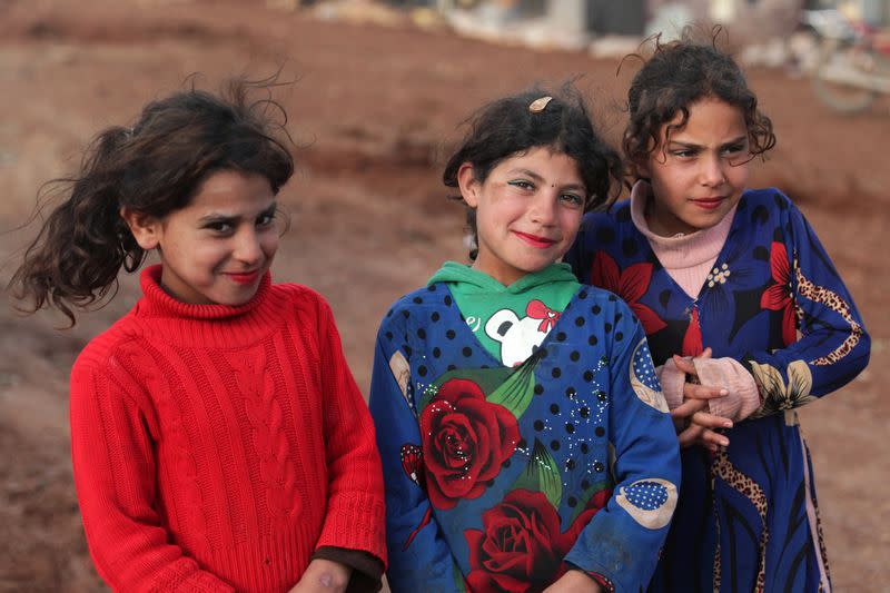 Internally displaced girls pose for a picture at a makeshift camp in Azaz