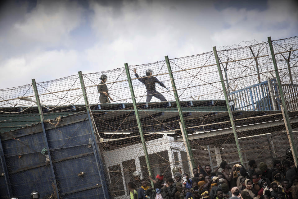 Migrants arrive on Spanish soil after crossing the fences separating the Spanish enclave of Melilla from Morocco in Melilla, Spain, Friday, June 24, 2022. Dozens of migrants stormed the border crossing between Morocco and the Spanish enclave city of Melilla on Friday in what is the first such incursion since Spain and Morocco mended diplomatic relations last month. (AP Photo/Javier Bernardo)