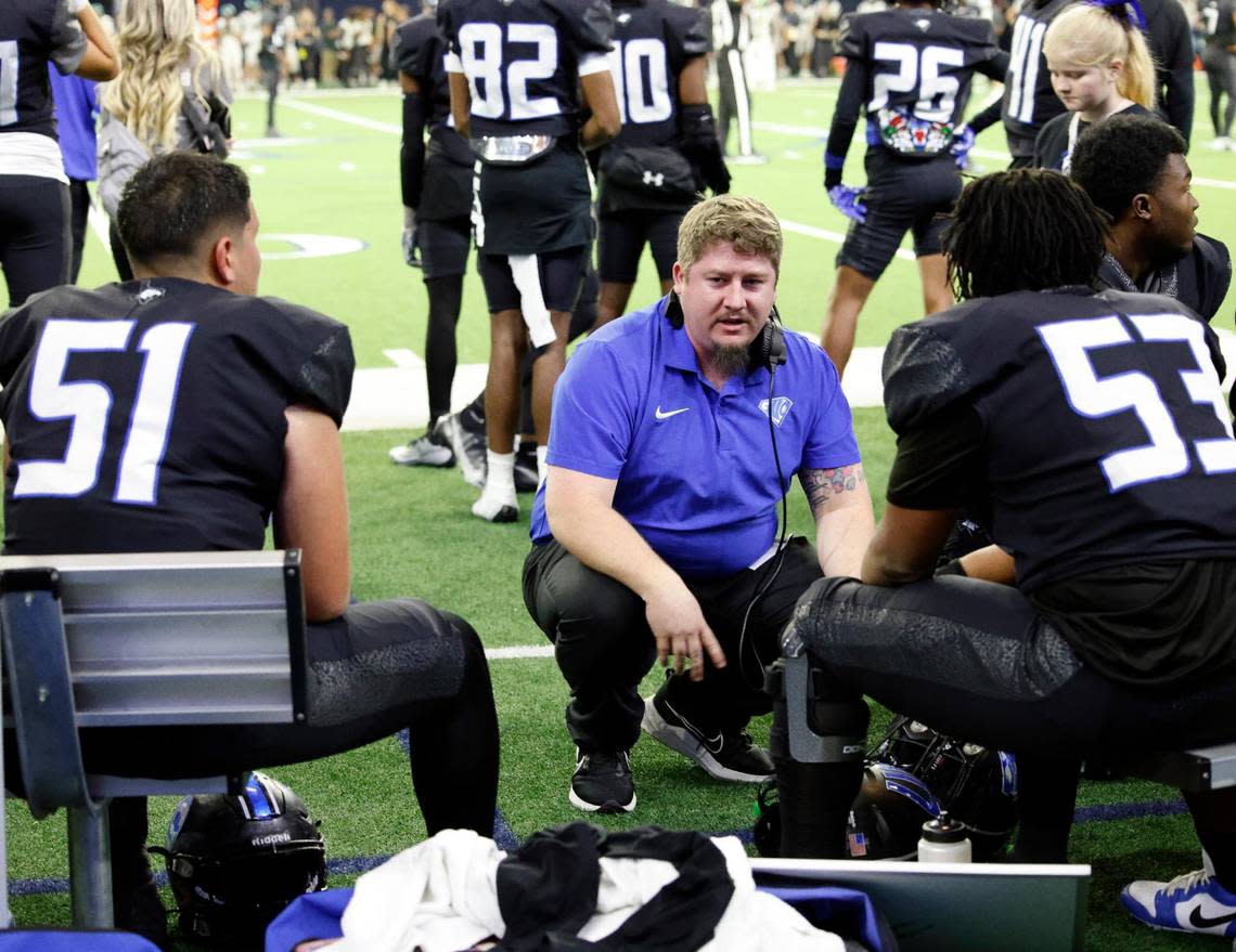 Offensive line coach Zach Calhoun instructs his players in the first half of a UIL Class 6A Division 1 football regional-round playoff game at The Ford Center in Frisco, Texas, Saturday, Oct. 25, 2023.