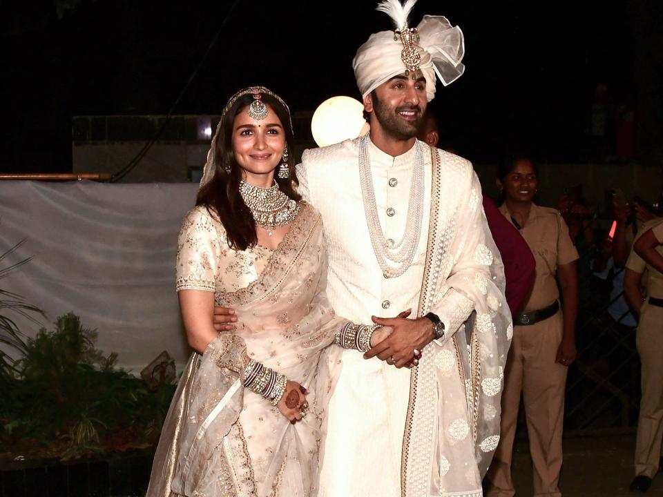 Bollywood actors Ranbir Kapoor (R) and Alia Bhatt pose for pictures during their wedding ceremony in Mumbai on April 14, 2022