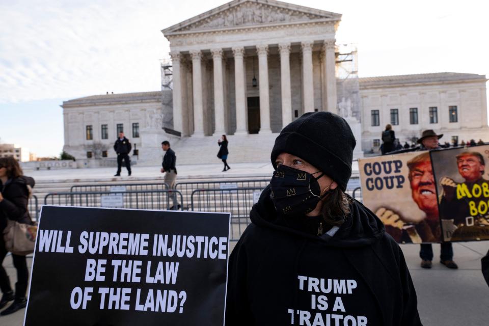 Anti-Trump demonstrators protest outside the U.S. Supreme Court  on Feb. 8, 2024, as the court considers whether former President Donald Trump is eligible to run for president in the 2024 election.