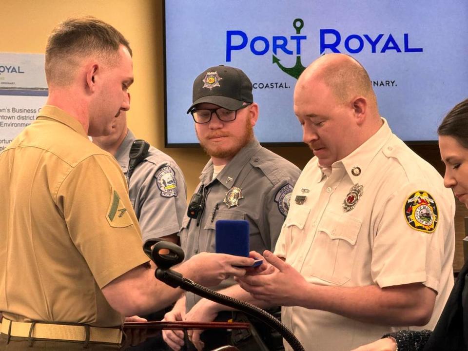 Jayden Pearman presents a life-saving award to Matt Domanski, a paramedic with the Beaufort-Port Royal Fire Department. On Nov. 1, 2023, Domanski performed a procedure called a needle decompression on Pearman that allowed him to breathe.