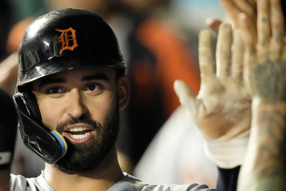 Detroit Tigers' Riley Greene celebrates in the dugout after scoring on a two-run double hit by Matt Vierling during the eighth inning of a baseball game against the Kansas City Royals Monday, July 17, 2023, in Kansas City, Mo. (AP Photo/Charlie Riedel)