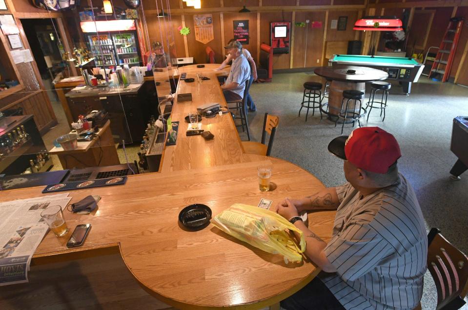 Jake Neal, 54, lower right, has a beer, May 29, 2020, at The Pit Stop bar in Meadville, the first day that non-essential businesses in Crawford County moved to the green phase of reduced restrictions as some counties in Pennsylvania reopen after shutdowns related to COVID-19, the new coronavirus.