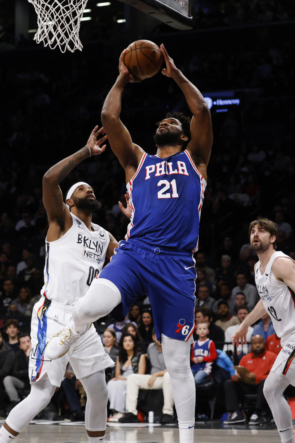 Philadelphia 76ers' Joel Embiid (21) shoots against Brooklyn Nets' Royce O'Neale (00) during the first quarter of an NBA basketball game Saturday, Feb. 11, 2023, in New York. (AP Photo/Jason DeCrow)