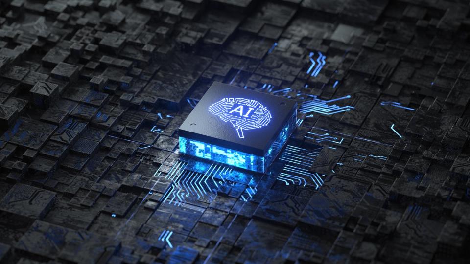 A digital rendering of a circuit board with a chip in the center, with AI inscribed on it.