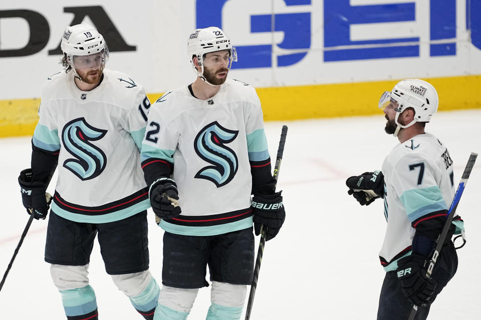 Seattle Kraken's Jared McCann (19), Oliver Bjorkstrand (22) and Jordan Eberle (7) celebrate after Bjorkstrand scored in the third period of Game 7 of an NHL hockey Stanley Cup second-round playoff series against the Dallas Stars, Monday, May 15, 2023, in Dallas. (AP Photo/Tony Gutierrez)