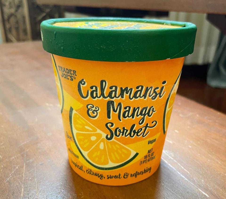 A container of Trader Joe's Calamansi & Mango Sorbet on a table