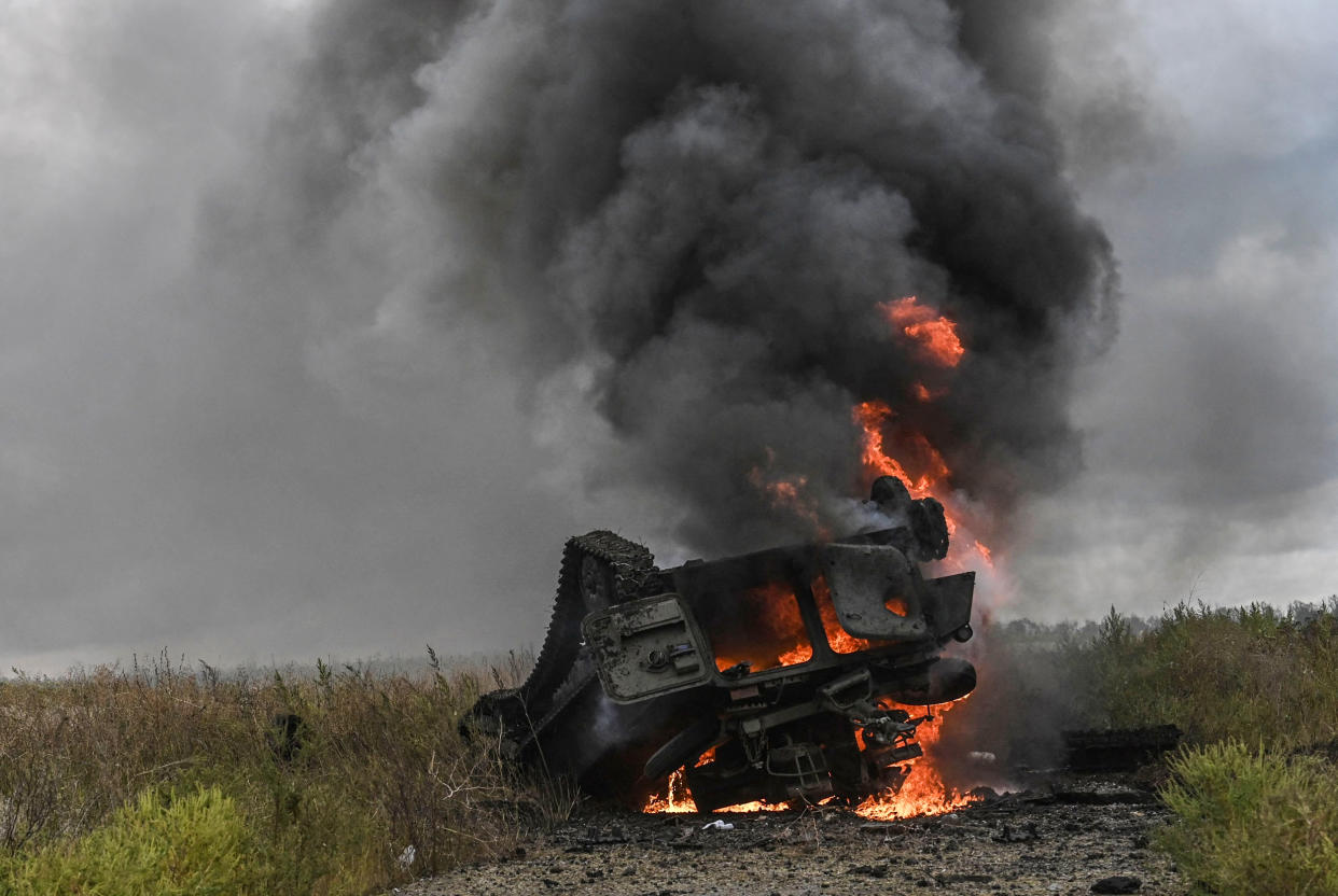 A destroyed Russian MT-LB armored personnel carrier burns in a field on the outskirts of Izyum, Kharkiv Region, eastern Ukraine, on Sept. 14, 2022. (Juan Barreto / AFP - Getty Images)