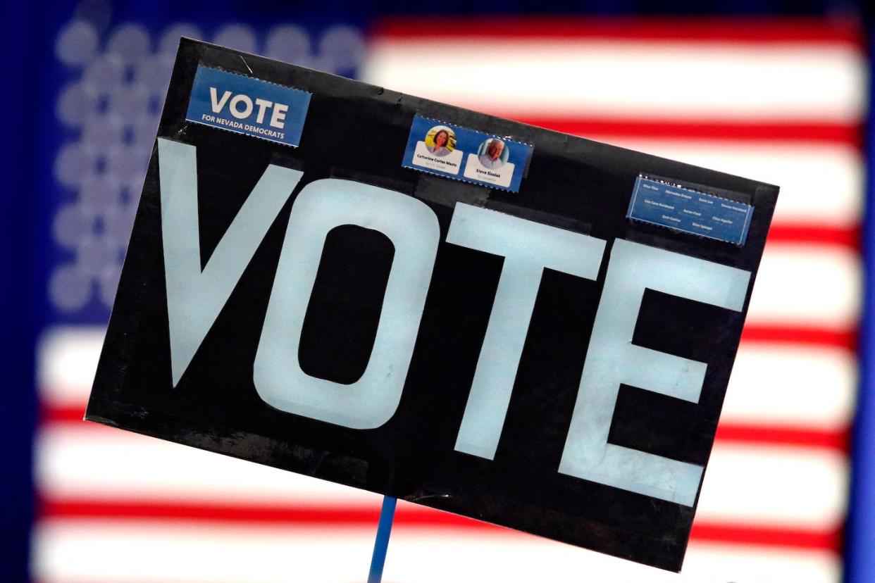 A vote sign appears at a campaign event for Nevada Gov. Steve Sisolak and U.S. Sen. Catherine Cortez Mastro in Las Vegas on Nov. 1, 2022. <a href="https://media.gettyimages.com/photos/an-attendees-sign-reading-vote-is-pictured-during-a-campaign-event-picture-id1244419536?s=612x612" rel="nofollow noopener" target="_blank" data-ylk="slk:Ronda Churchill/AFP via Getty Images;elm:context_link;itc:0;sec:content-canvas" class="link ">Ronda Churchill/AFP via Getty Images</a>