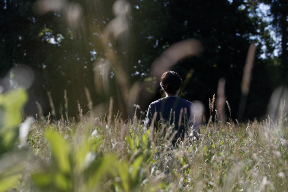 Sydney Shumar with the Patuxent Wildlife Research Center, walks though a field of milkweed and grasses at the Patuxent Wildlife Research Center in Laurel, Maryland, Friday, May 31, 2019. (AP Photo/Carolyn Kaster)