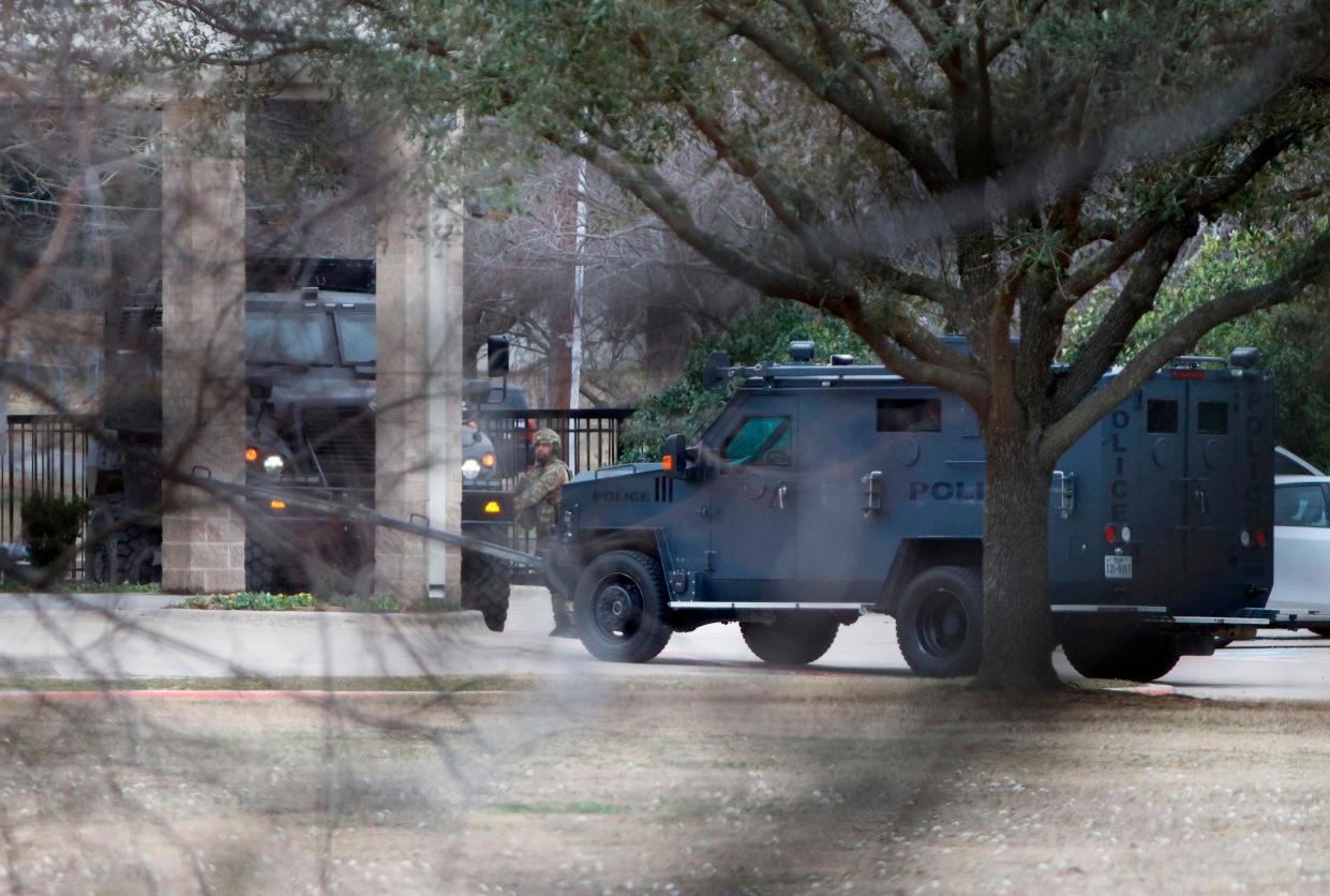 Law enforcement teams stage near Congregation Beth Israel in Colleyville, Texas on Saturday. Authorities said a man took hostages Saturday during services at the synagogue. On a Facebook livestream, the man was heard demanding the release of a Pakistani neuroscientist convicted of trying to kill U.S. Army officers in Afghanistan. 