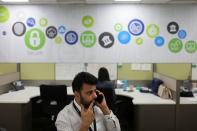 A man talks on the phone at Deloitte's office in Gurugram