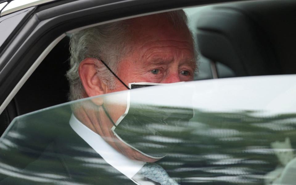 Prince Charles, Prince of Wales, wearing a face covering, travels to the State Opening of Parliament  - AFP