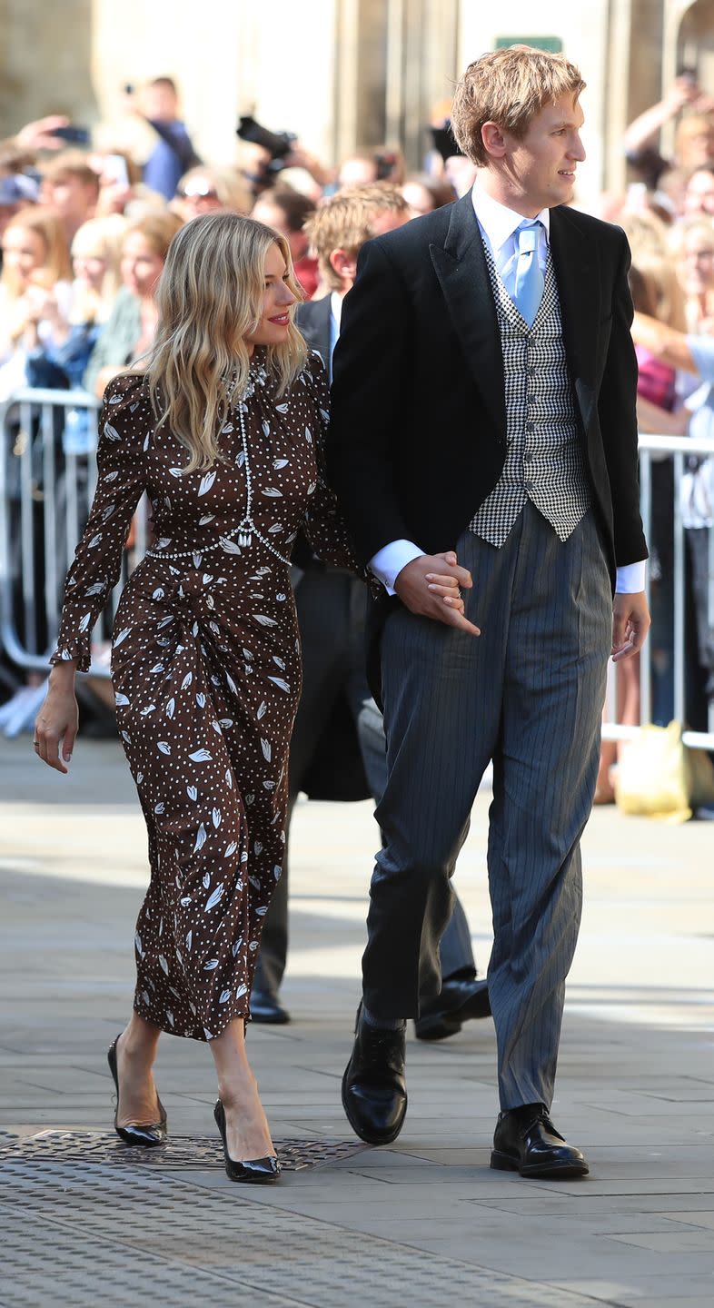 Sienna Miller arrives at the wedding with Lucas Zwirner.