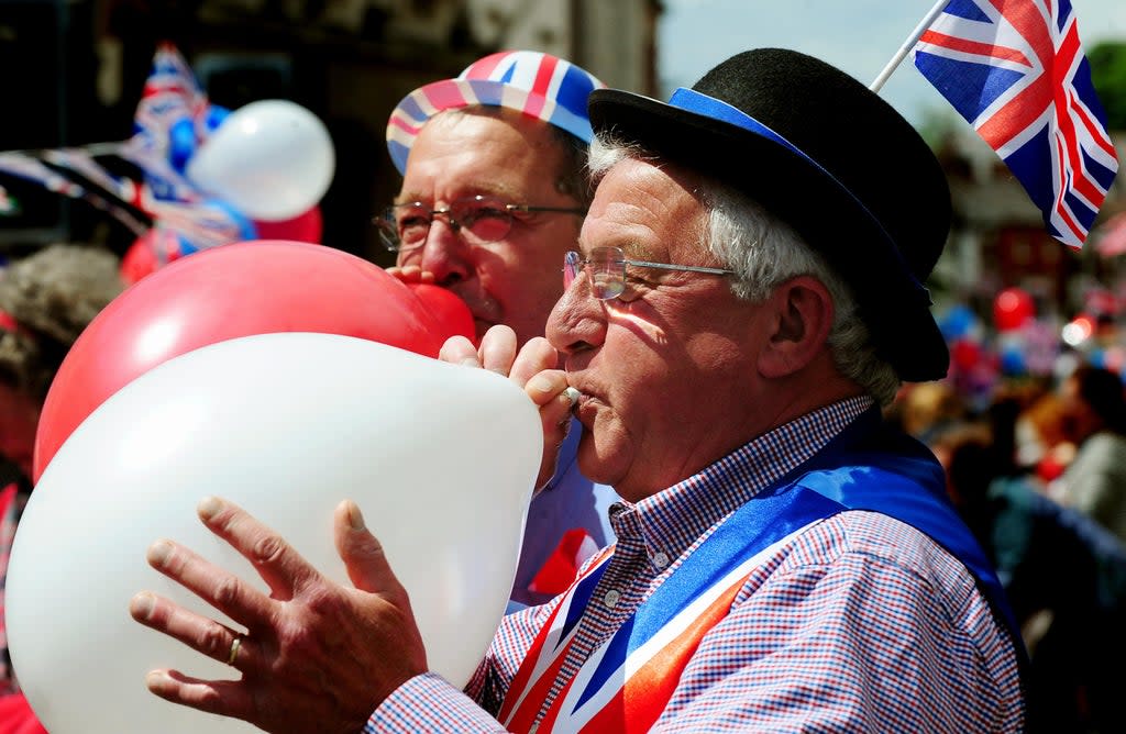 People celebrate the Queen’s Diamond Jubilee in 2012 (Rui Vieira/PA) (PA Archive)