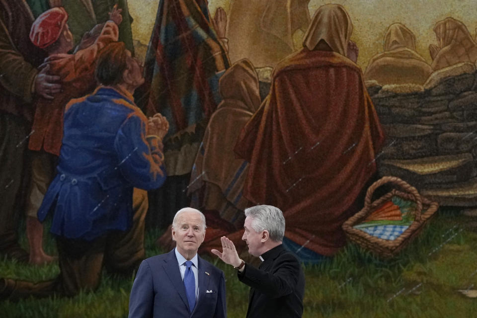 President Joe Biden tours the Knock Shrine with Father Richard Gibbons, parish priest and rector of Knock Shrine, in Knock, Ireland, Friday, April 14, 2023. (AP Photo/Patrick Semansky)