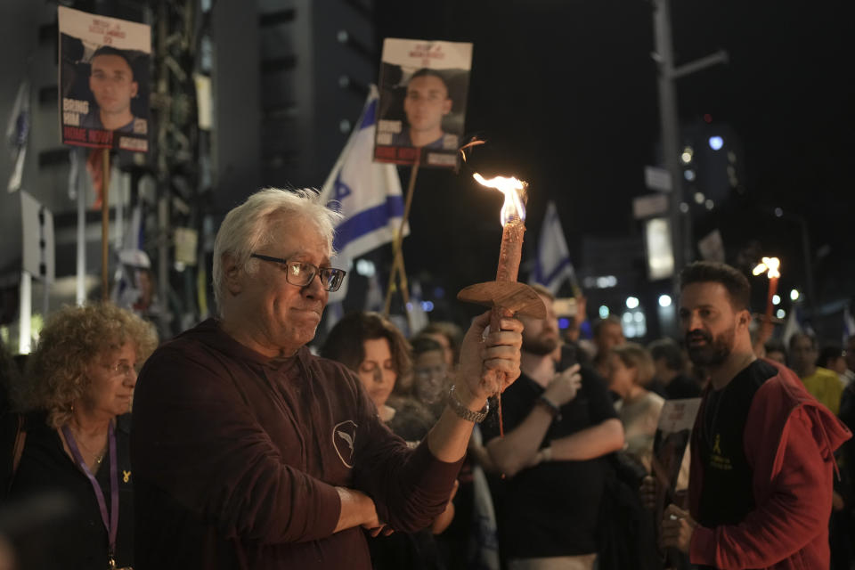 People take part in a protest against Israeli Prime Minister Benjamin Netanyahu's government and call for the release of hostages held in the Gaza Strip by the Hamas militant group, in Tel Aviv, Israel, Saturday, March 30, 2024. (AP Photo/Maya Alleruzzo)