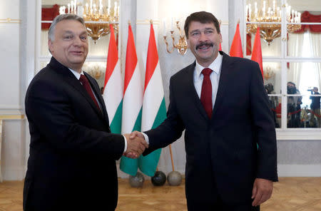 Hungarian President Janos Ader welcomes Hungarian Prime Minister Viktor Orban at the Presidential Palace in Budapest, Hungary, May 7, 2018. REUTERS/Bernadett Szabo