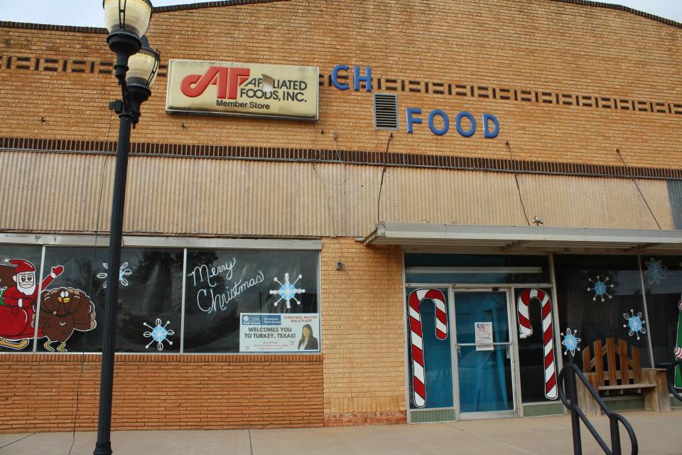 A closed grocery store is pictured with a for sale sign in the front window on Thursday in Turkey.