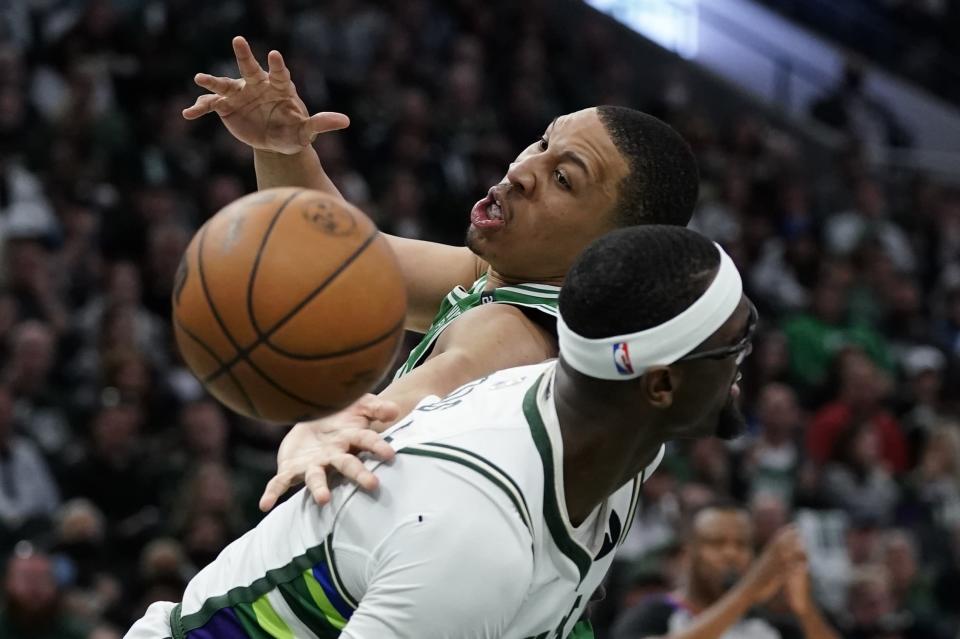 Boston Celtics' Grant Williams is fouled by Milwaukee Bucks' Bobby Portis during the second half of Game 3 of an NBA basketball Eastern Conference semifinals playoff series Saturday, May 7, 2022, in Milwaukee. The Bucks won 103-101 to take a 2-0 lead in the series. (AP Photo/Morry Gash)