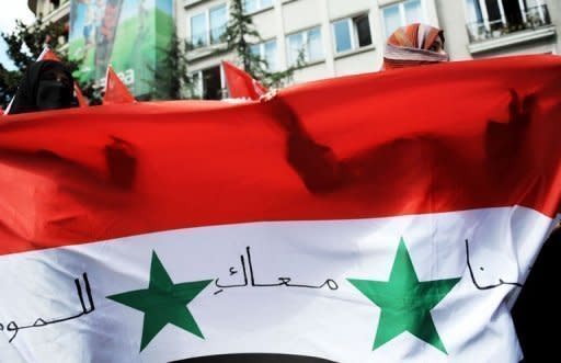 Women hold a Syrian flag during a demonstration in Turkey against Syria's regime of President Bashar al-Assad on August 7, in front of the Syrian consulate in Istanbul. Saudi Arabia and Kuwait recalled their envoys to Damascus after the Arab League condemned violence in Syria, leaving President Bashar al-Assad further isolated as he defended his crackdown on "outlaws."